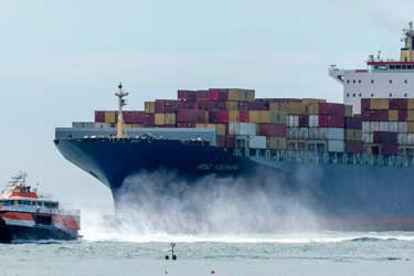 A Large Cargo Ship In The Ocean With A Tug Boat Nearby Mnk7lwh0ixq E6fe0b05896dbf81053c67a9a21c7f34